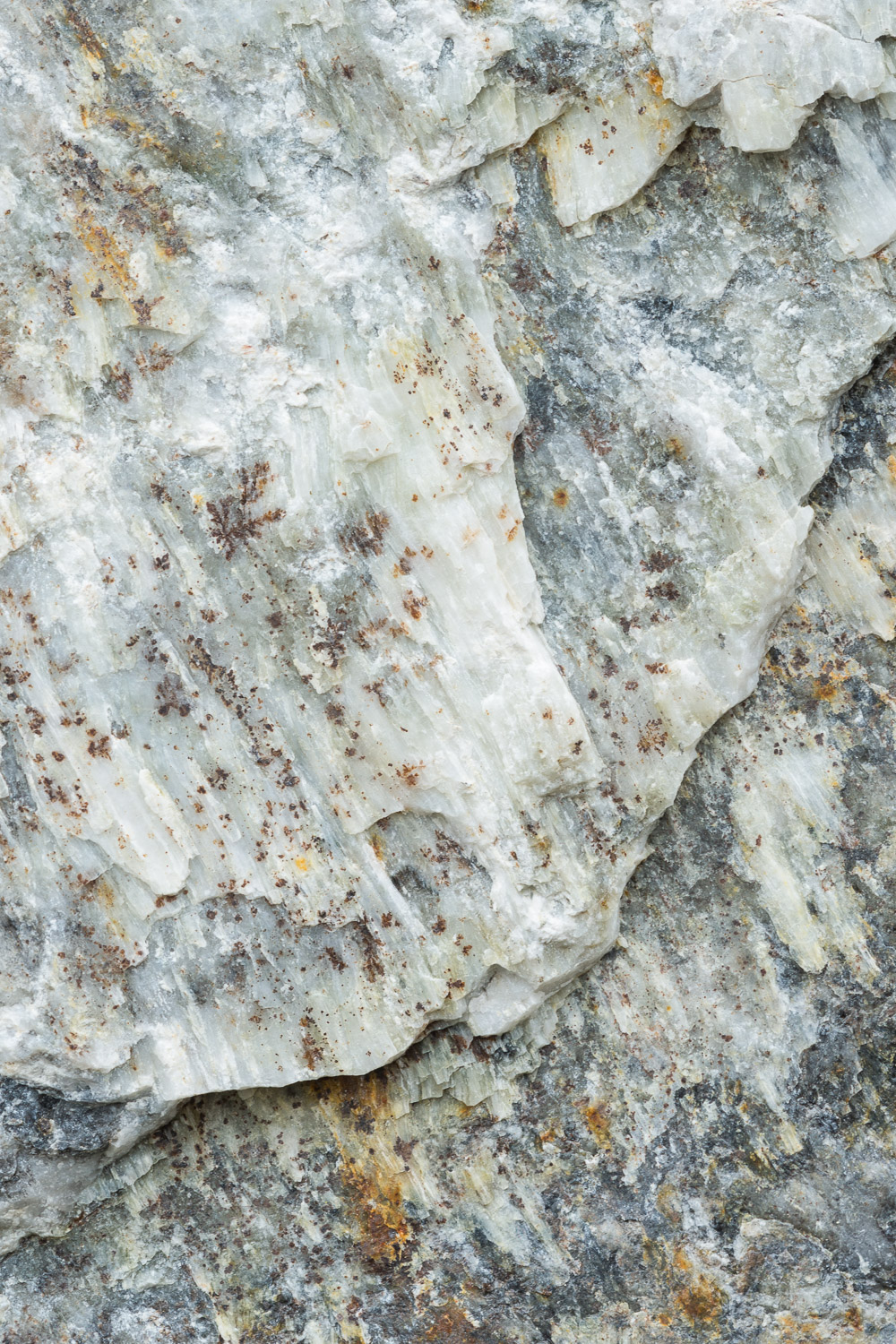 Close-up of the colors and textures in quarried limestone rock used in the construction of a retaining wall. Image #3724